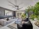 Bright living room with comfortable seating, patio view, and modern art at 1174 Villa Ln # 115, Apopka, FL 32712
