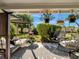 Inviting outdoor porch featuring multiple seating options, potted plants, and a lovely garden view at 1174 Villa Ln # 115, Apopka, FL 32712