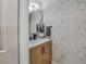 Stylish powder room with modern vanity, sleek fixtures, and luxurious marble accent wall at 1174 Villa Ln # 115, Apopka, FL 32712