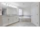 Spacious bathroom featuring dual vanities, a luxurious soaking tub, and stylish tile work at 11810 Imaginary Way, Orlando, FL 32832