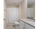 Bathroom featuring a shower-tub combo, single sink vanity, and neutral color palette at 11810 Imaginary Way, Orlando, FL 32832
