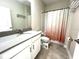 Bathroom featuring a vanity, mirror, and shower with a decorative curtain at 11810 Imaginary Way, Orlando, FL 32832
