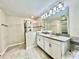 Bathroom featuring a double vanity with a tiled glass shower at 11810 Imaginary Way, Orlando, FL 32832