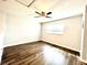 Bedroom features wood-look floors, ceiling fan, and window with blinds at 11810 Imaginary Way, Orlando, FL 32832