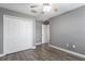 Neutral bedroom with closet, ceiling fan, and wood-look flooring at 11810 Imaginary Way, Orlando, FL 32832