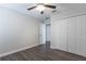 Simple bedroom featuring laminate flooring, ceiling fan, and double door closet at 11810 Imaginary Way, Orlando, FL 32832