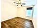Bedroom featuring wood-look flooring, a ceiling fan, and a window with blinds at 11810 Imaginary Way, Orlando, FL 32832