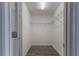 Empty walk-in closet with wire shelving and gray laminate flooring at 11810 Imaginary Way, Orlando, FL 32832