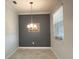 Traditional dining room featuring tile flooring, a chandelier, and a large window at 11810 Imaginary Way, Orlando, FL 32832