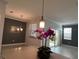Dining area with modern lighting, neutral walls, and tile flooring leading to a patio at 11810 Imaginary Way, Orlando, FL 32832