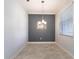 Dining room with modern chandelier, neutral color palette, and tile flooring at 11810 Imaginary Way, Orlando, FL 32832