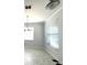 Bright dining room with tiled floors, large windows, and a modern chandelier fixture at 11810 Imaginary Way, Orlando, FL 32832