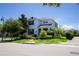 Charming two-story home with blue shutters and meticulously landscaped front yard, creating a welcoming curb appeal at 11810 Imaginary Way, Orlando, FL 32832