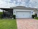 Lovely home with a brick driveway, attached two-car garage, and screened in lanai at 11810 Imaginary Way, Orlando, FL 32832