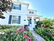 Beautiful two-story home with lush landscaping, blue shutters, and a charming brick walkway at 11810 Imaginary Way, Orlando, FL 32832