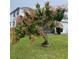 Inviting front yard featuring a mature mango tree and lush green lawn at 11810 Imaginary Way, Orlando, FL 32832