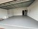 Spacious and clean garage with painted floors and visible water heater and mechanicals at 11810 Imaginary Way, Orlando, FL 32832
