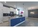 Well-lit kitchen featuring stainless steel appliances, white cabinets, and a large center island with a modern design at 11810 Imaginary Way, Orlando, FL 32832