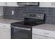 Modern kitchen with stainless steel appliances, gray backsplash, and quartz countertops at 11810 Imaginary Way, Orlando, FL 32832