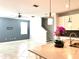 Open living space next to the kitchen, stairs to the second floor, and modern ceiling fan at 11810 Imaginary Way, Orlando, FL 32832