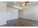 Clean and bright main bedroom with hardwood floors, ceiling fan, and walk-in closet at 11810 Imaginary Way, Orlando, FL 32832