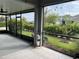 Large screened-in lanai provides serene outdoor living space with views of the landscaped backyard at 11810 Imaginary Way, Orlando, FL 32832