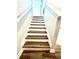 A staircase with wood-look steps and white risers at 11810 Imaginary Way, Orlando, FL 32832