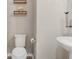Powder room featuring a toilet, floating shelves, and a modern sink at 11980 Sands Cv, Orlando, FL 32828