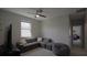 Cozy bonus room featuring neutral color palette, a corner sofa, and a ceiling fan for added comfort at 11980 Sands Cv, Orlando, FL 32828