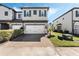 Charming two-story townhome with a two-car garage and a brick-paved driveway at 11980 Sands Cv, Orlando, FL 32828