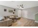 Spacious living room with wood-look tile flooring, a ceiling fan, and neutral paint at 11980 Sands Cv, Orlando, FL 32828