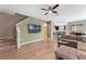 Open-concept living room with tile floors and a TV; kitchen is in background at 11980 Sands Cv, Orlando, FL 32828