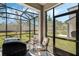 Enclosed patio with a grill, seating, and a view of the backyard at 11980 Sands Cv, Orlando, FL 32828