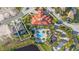 Aerial view of the property's proximity to the community clubhouse, pool, and other amenities and the surrounding area at 1205 Butterfly Orchid Rd, Davenport, FL 33837