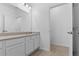 Bright bathroom featuring a white vanity with solid surface countertop and tile flooring at 1205 Butterfly Orchid Rd, Davenport, FL 33837