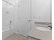A bright bathroom features a granite countertop, a tiled shower, and tile flooring at 1205 Butterfly Orchid Rd, Davenport, FL 33837