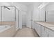 A luxurious bathroom with a soaking tub and glass-enclosed shower at 1205 Butterfly Orchid Rd, Davenport, FL 33837