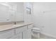 Light-filled bathroom featuring quartz countertop and modern fixtures at 1205 Butterfly Orchid Rd, Davenport, FL 33837
