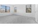 Bright, spacious bedroom with plush gray carpet, two windows with blinds, and neutral paint at 1205 Butterfly Orchid Rd, Davenport, FL 33837