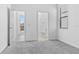 Neutral bedroom featuring plush gray carpet, an open doorway to a bath, and natural light from a window at 1205 Butterfly Orchid Rd, Davenport, FL 33837
