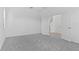 Spacious bedroom with plush gray carpeting, white walls, and ample natural light from two windows at 1205 Butterfly Orchid Rd, Davenport, FL 33837