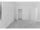 Bright bedroom features neutral tones, plush carpeting, and a walk-in closet at 1205 Butterfly Orchid Rd, Davenport, FL 33837