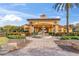 Elegant community clubhouse with a fountain, lush landscaping, and decorative architectural details in a beautiful setting at 1205 Butterfly Orchid Rd, Davenport, FL 33837