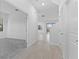 Inviting entryway with tile flooring and a view of the staircase and the spacious living area at 1205 Butterfly Orchid Rd, Davenport, FL 33837