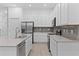 Modern kitchen featuring white cabinets, stainless steel appliances, and sleek countertops at 1205 Butterfly Orchid Rd, Davenport, FL 33837