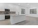 Bright, all white kitchen featuring an island, modern appliances, and tile flooring at 1205 Butterfly Orchid Rd, Davenport, FL 33837