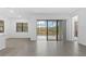 Bright living room with tile flooring and sliding glass doors leading to the pool area at 1205 Butterfly Orchid Rd, Davenport, FL 33837