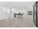 Spacious living space with tile floors and an adjacent modern kitchen, perfect for entertaining at 1205 Butterfly Orchid Rd, Davenport, FL 33837