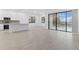 Open-concept living space featuring tile floors, a kitchen island, and large sliding glass doors at 1205 Butterfly Orchid Rd, Davenport, FL 33837