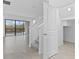 View of a living space with stairs and sliding doors leading to the pool area at 1205 Butterfly Orchid Rd, Davenport, FL 33837